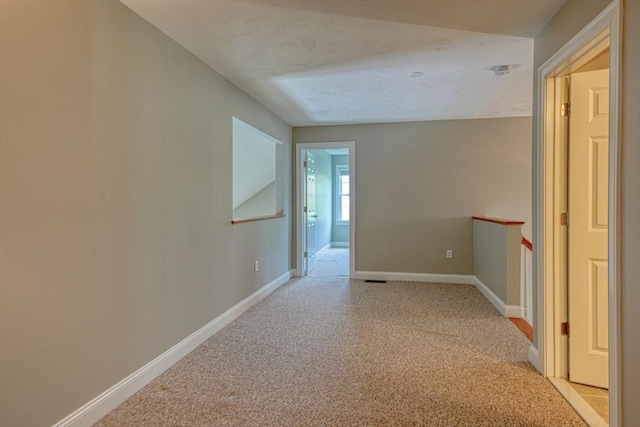 39 Balancing Rock Dr Unit 39, Holliston, MA 01746 - hall with light carpet and an upstairs landing