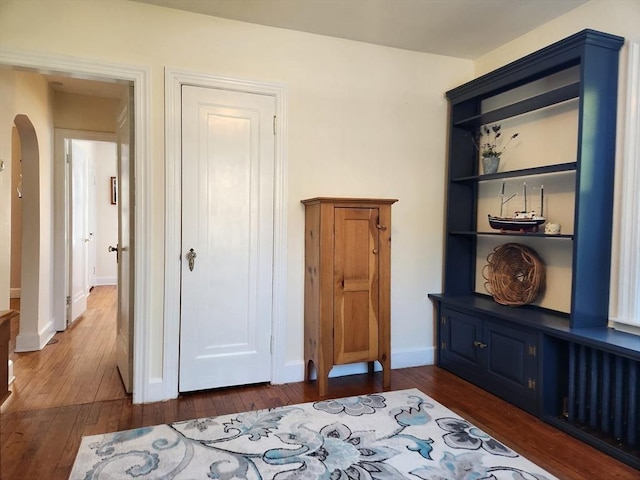 bedroom with dark wood-type flooring