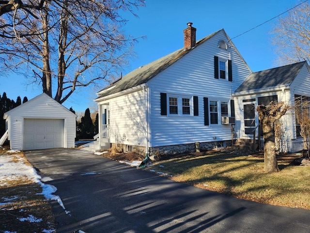 view of side of home with a garage and an outdoor structure