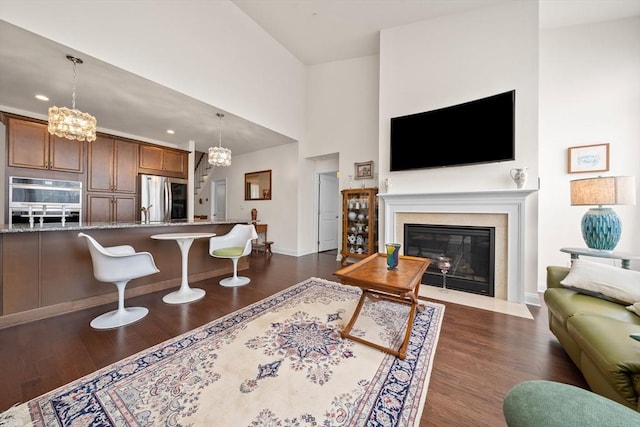 4 Helen Ln Unit 4, Millis, MA 02054 - living area featuring a chandelier, a fireplace with flush hearth, dark wood-style flooring, baseboards, and recessed lighting