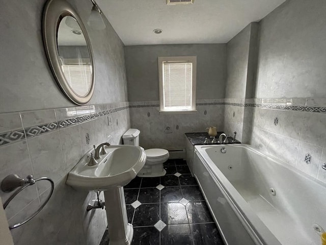 bathroom featuring toilet, a baseboard radiator, tile patterned floors, a jetted tub, and a sink