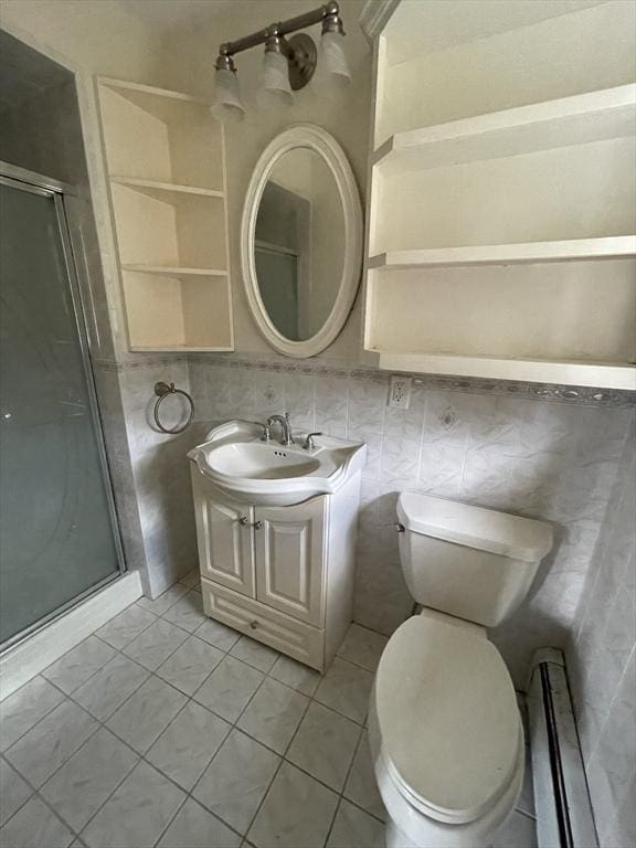 bathroom featuring a stall shower, tile patterned flooring, vanity, and toilet