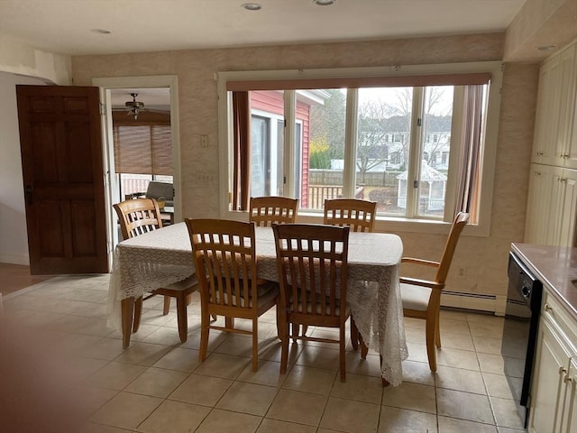 dining area with a baseboard heating unit and light tile patterned flooring