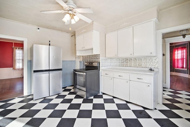 kitchen with white cabinetry, stainless steel appliances, backsplash, ornamental molding, and ceiling fan