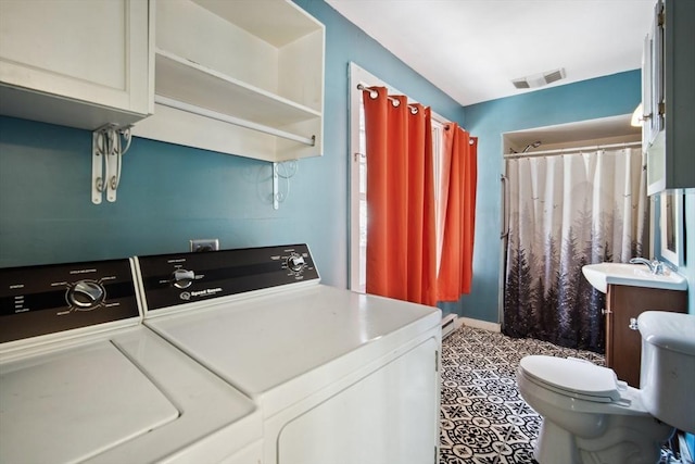 laundry room with washer and dryer, sink, and baseboard heating