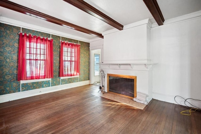 unfurnished living room with hardwood / wood-style flooring, ornamental molding, and beamed ceiling