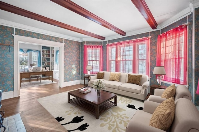 living room featuring wood-type flooring, crown molding, beamed ceiling, and a healthy amount of sunlight