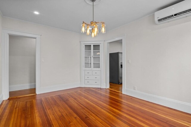 37 Fountain Rd Unit 2, Arlington, MA 02476 - unfurnished dining area with a wall unit AC, a chandelier, wood finished floors, baseboards, and crown molding