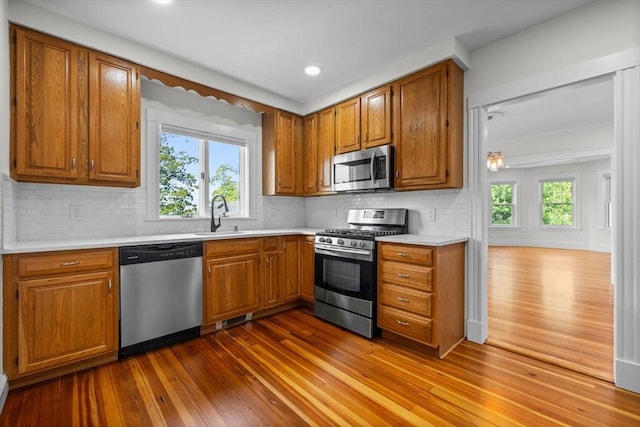 37 Fountain Rd Unit 2, Arlington, MA 02476 - kitchen with stainless steel appliances, a sink, dark wood-style flooring, brown cabinets, and recessed lighting