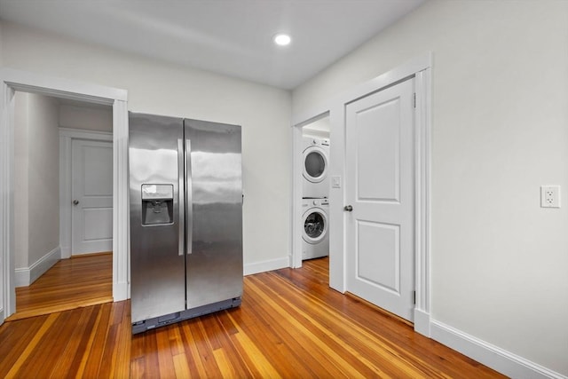 37 Fountain Rd Unit 2, Arlington, MA 02476 - kitchen with stainless steel refrigerator with ice dispenser, stacked washing machine and dryer, hardwood / wood-style flooring, baseboards, and recessed lighting
