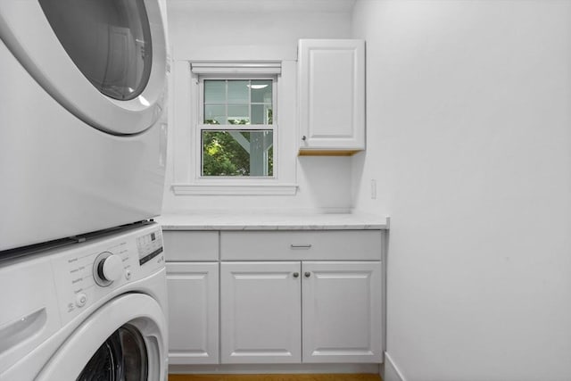 37 Fountain Rd Unit 2, Arlington, MA 02476 - washroom with cabinet space and stacked washing machine and dryer