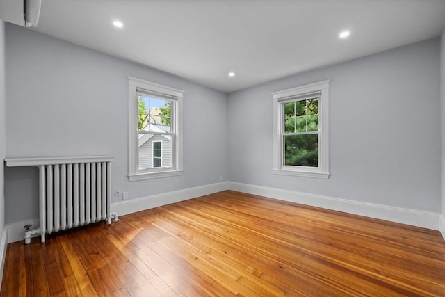 37 Fountain Rd Unit 2, Arlington, MA 02476 - unfurnished room featuring radiator heating unit, plenty of natural light, baseboards, hardwood / wood-style flooring, and recessed lighting