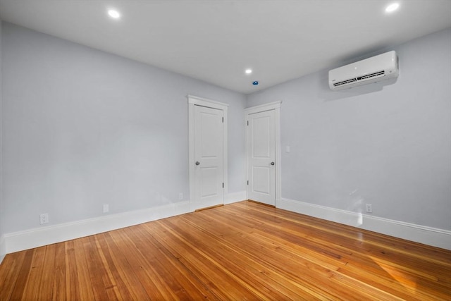 37 Fountain Rd Unit 2, Arlington, MA 02476 - spare room featuring an AC wall unit, recessed lighting, baseboards, and hardwood / wood-style floors