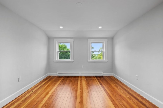37 Fountain Rd Unit 2, Arlington, MA 02476 - spare room featuring a baseboard radiator, hardwood / wood-style floors, baseboards, and vaulted ceiling