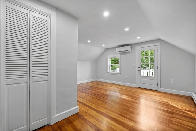 37 Fountain Rd Unit 2, Arlington, MA 02476 - bonus room with an AC wall unit, baseboards, vaulted ceiling, recessed lighting, and light wood finished floors