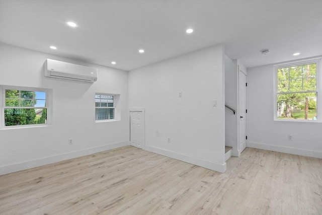 37 Fountain Rd Unit 2, Arlington, MA 02476 - unfurnished room with a wall mounted air conditioner, wood finished floors, recessed lighting, and baseboards