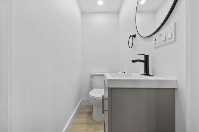 37 Fountain Rd Unit 2, Arlington, MA 02476 - half bathroom with toilet, vanity, wood finished floors, recessed lighting, and baseboards