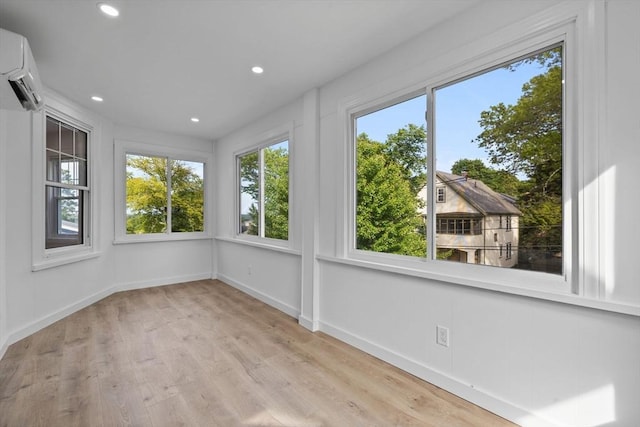 37 Fountain Rd Unit 2, Arlington, MA 02476 - unfurnished sunroom with a wall unit AC, wood finished floors, baseboards, and recessed lighting