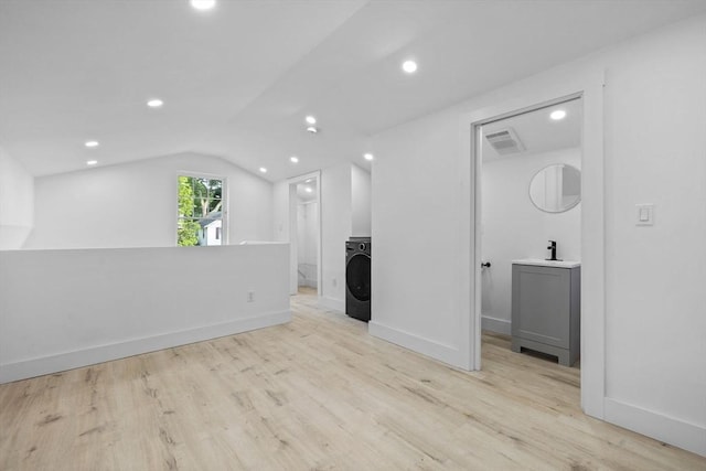37 Fountain Rd Unit 2, Arlington, MA 02476 - unfurnished living room with washer / clothes dryer, vaulted ceiling, light wood-type flooring, a sink, and recessed lighting