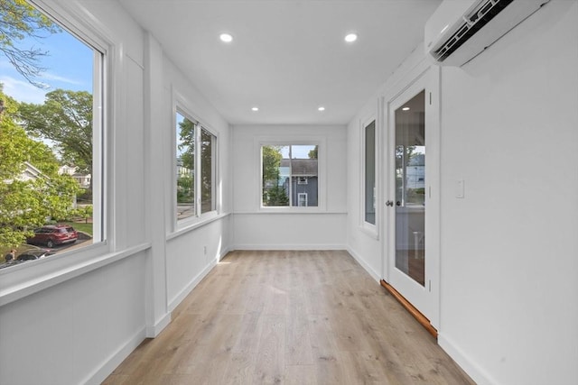 37 Fountain Rd Unit 2, Arlington, MA 02476 - unfurnished sunroom with a wall unit AC, wood finished floors, recessed lighting, and baseboards