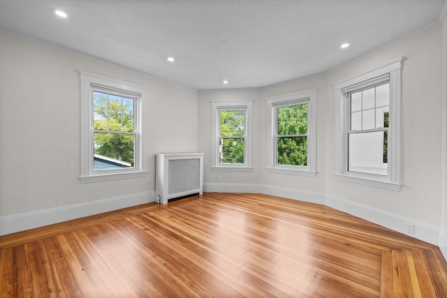 37 Fountain Rd Unit 2, Arlington, MA 02476 - unfurnished living room featuring radiator heating unit, healthy amount of natural light, baseboards, wood finished floors, and recessed lighting