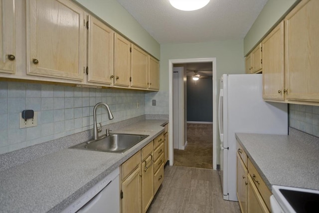 kitchen featuring light brown cabinetry, backsplash, and sink