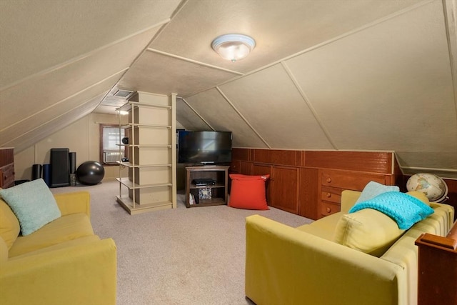 carpeted living room featuring lofted ceiling