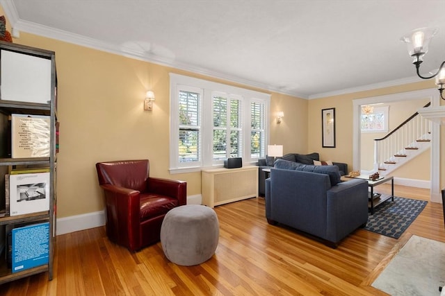 living room with crown molding, baseboards, stairway, and wood finished floors
