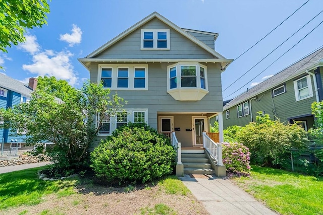 24 Parker St Unit 24, Arlington, MA 02474 - view of front of property with covered porch and a front yard
