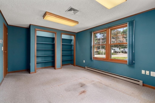 1 Joy St, Franklin, MA 02038 - unfurnished bedroom featuring a baseboard radiator, carpet floors, two closets, and a textured ceiling