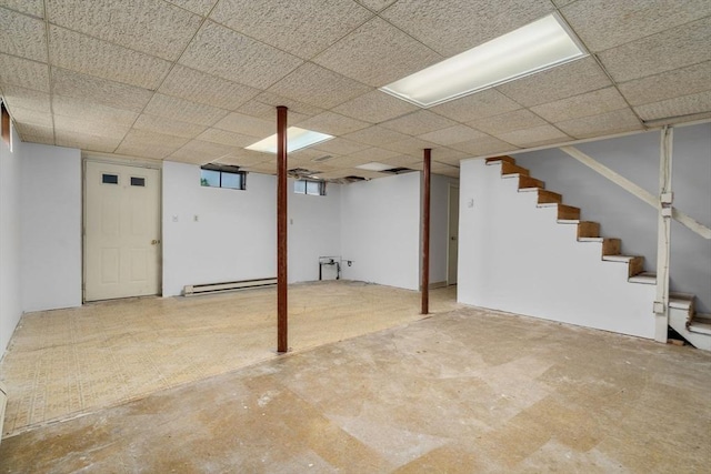 1 Joy St, Franklin, MA 02038 - below grade area featuring a baseboard radiator, stairway, and a paneled ceiling