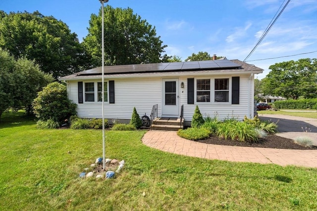 1 Joy St, Franklin, MA 02038 - view of front of property with roof mounted solar panels and a front yard