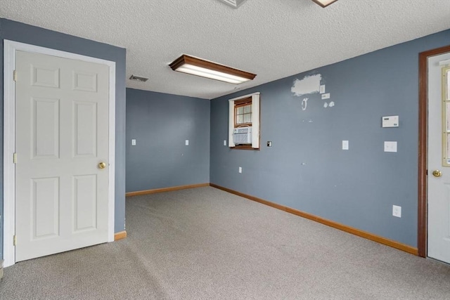 1 Joy St, Franklin, MA 02038 - empty room featuring carpet floors, a textured ceiling, and cooling unit