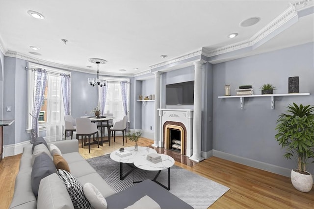 681 Massachusetts Ave Unit D, Boston, MA 02118 - living room featuring baseboards, ornamental molding, wood finished floors, a chandelier, and a fireplace with raised hearth