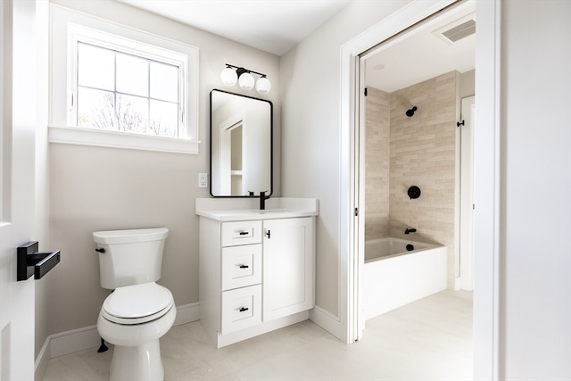 full bathroom featuring tiled shower / bath, vanity, and toilet