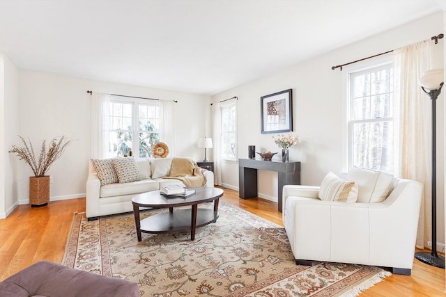 living room with light wood-style flooring and baseboards