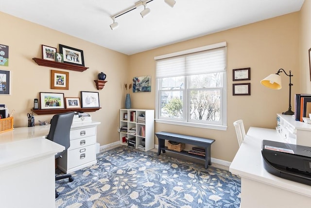 home office with track lighting and baseboards