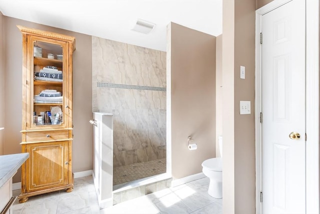 bathroom with toilet, a walk in shower, and baseboards