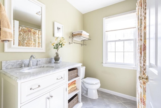 full bath featuring tile patterned floors, baseboards, toilet, and vanity