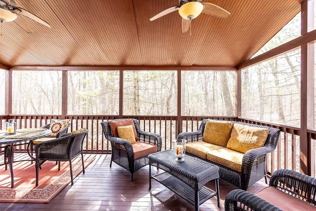 sunroom / solarium with a ceiling fan and vaulted ceiling