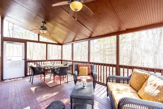 sunroom with wood ceiling, a ceiling fan, and vaulted ceiling