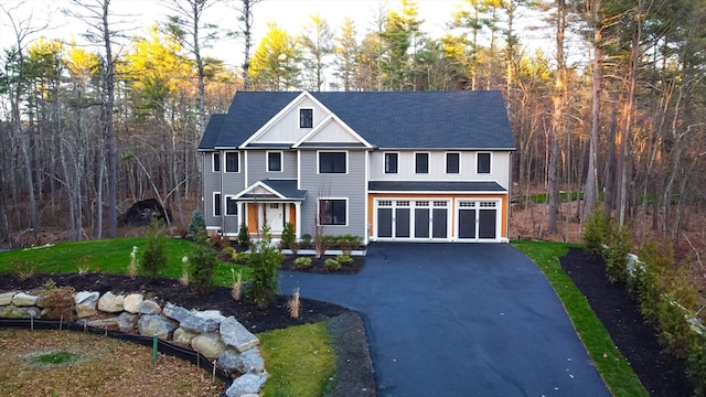 view of front of property with a front yard and a garage