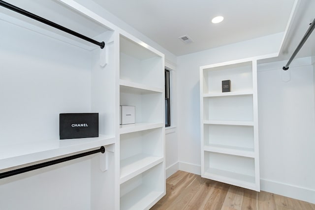 spacious closet with light hardwood / wood-style flooring