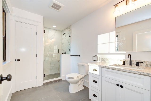 bathroom featuring tile patterned floors, vanity, toilet, and walk in shower