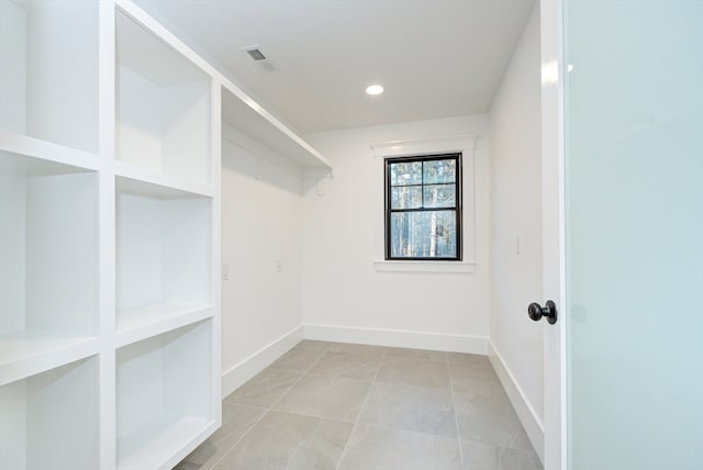 walk in closet with light tile patterned flooring