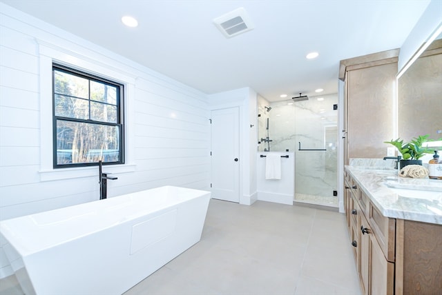 bathroom featuring vanity, shower with separate bathtub, and wooden walls