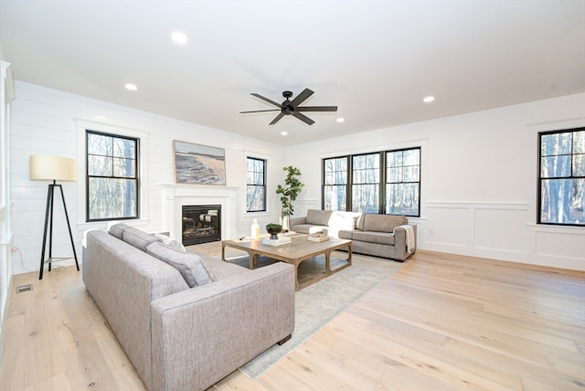 living room with ceiling fan, a healthy amount of sunlight, and light hardwood / wood-style floors