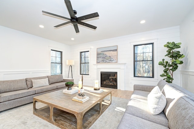 living room with ceiling fan, a healthy amount of sunlight, and light hardwood / wood-style floors