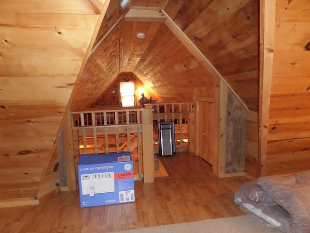 additional living space with wood-type flooring and lofted ceiling