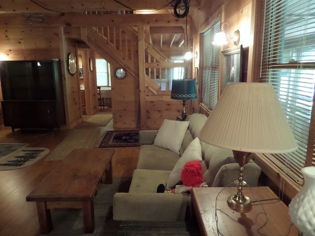 living room featuring wood walls and hardwood / wood-style floors